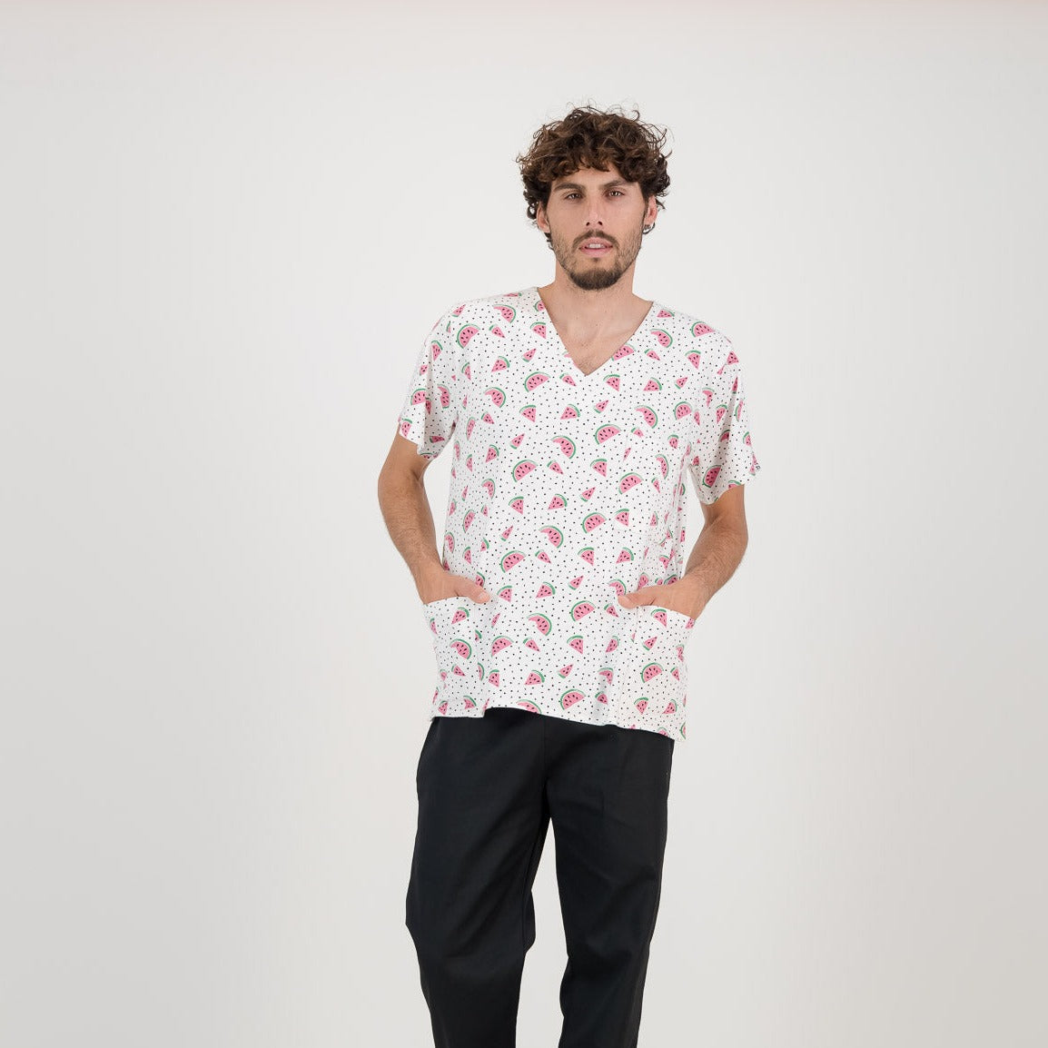 Model wearing  a watermelon styled scrub top.