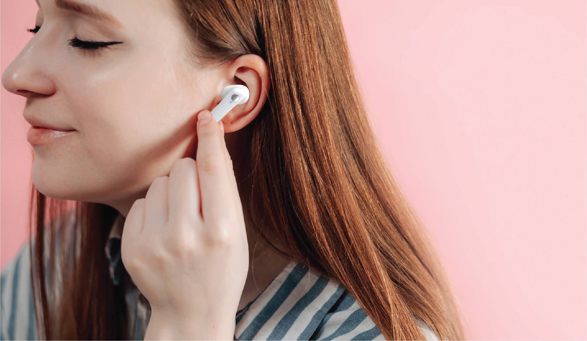 A woman using some sterile wireless earbuds